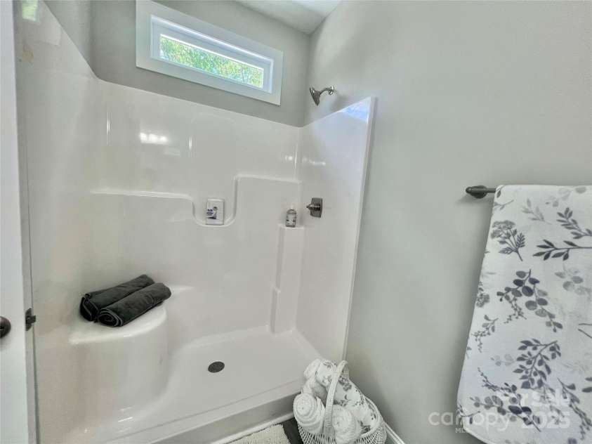 325 Jordan Avenue, Spencer, NC 28159.  MLS# CAR4269843, YatesRealty ID 24867. Primary bath~Walk in shower with seat