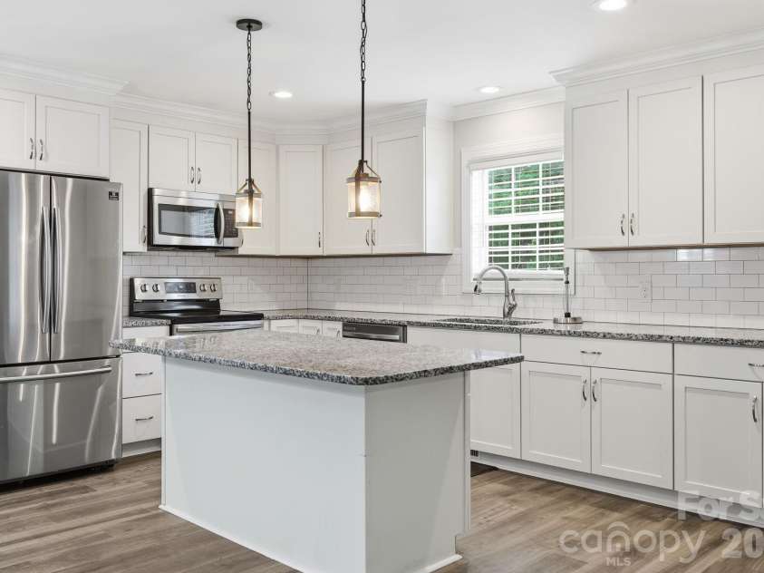2601 Penninger Road, Concord, NC 28025.  MLS# CAR4381603, YatesRealty ID 24870. Kitchen Island and stainless appliances