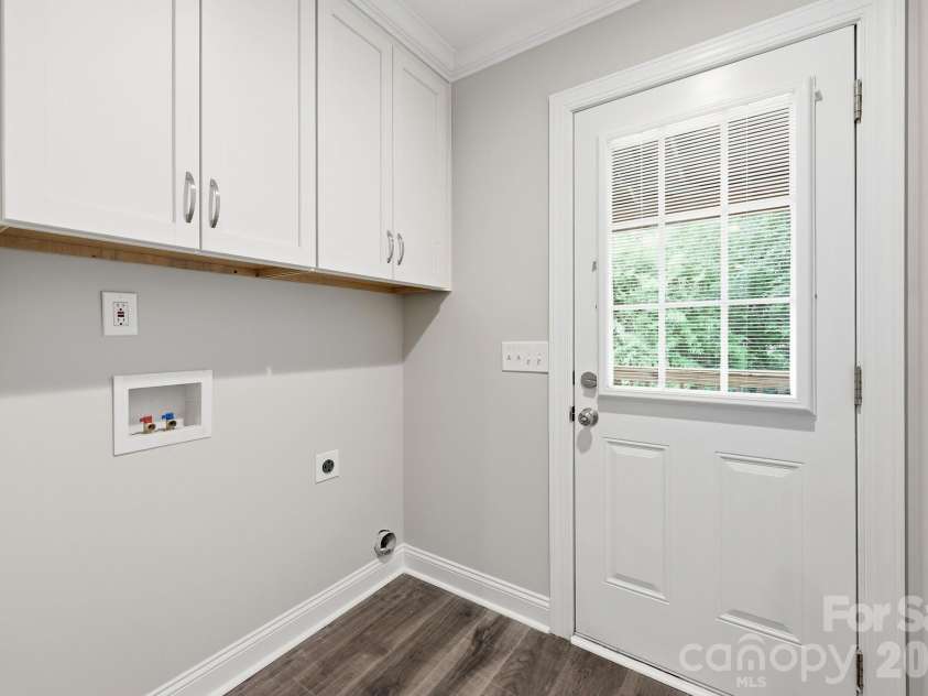 2601 Penninger Road, Concord, NC 28025.  MLS# CAR4381603, YatesRealty ID 24870. Laundry room with cabinets above