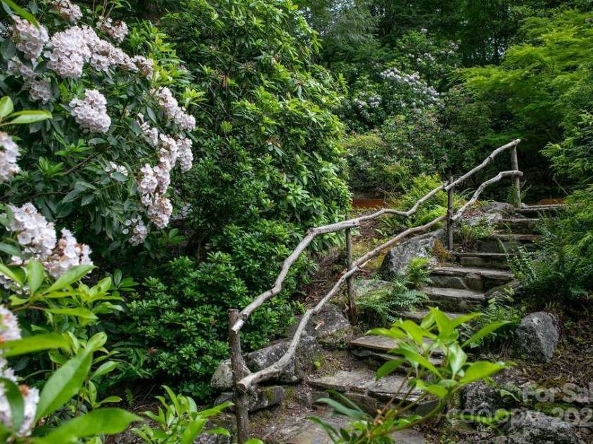 92 Nodatsi Court, Brevard, NC 28712.  MLS# CAR4268723, YatesRealty ID 24873. Beautiful rock stairs lead from the front yard to the back gardens...