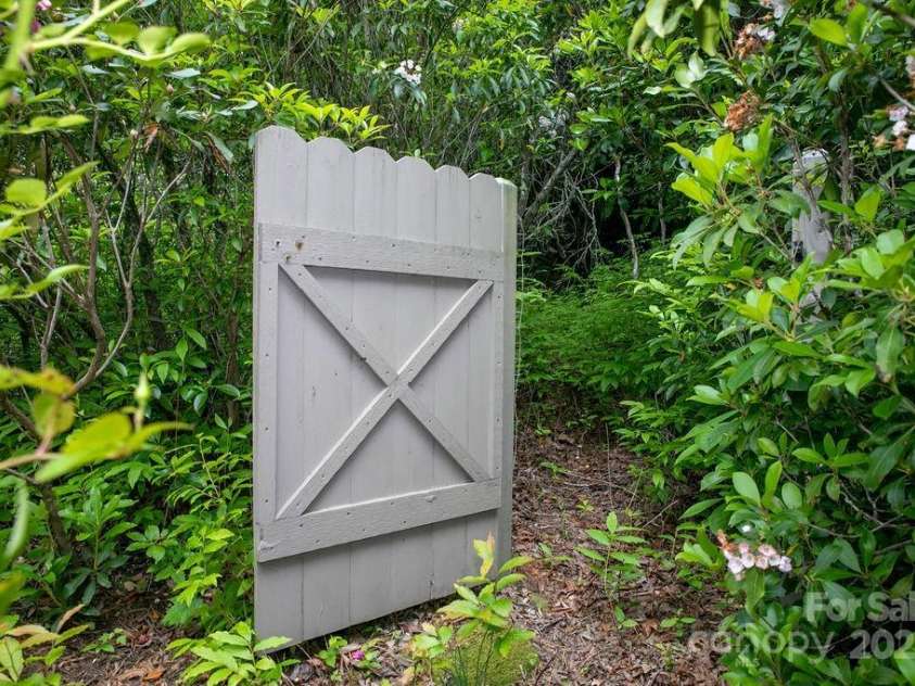 92 Nodatsi Court, Brevard, NC 28712.  MLS# CAR4268723, YatesRealty ID 24873. Gate connects second lot to back yard...