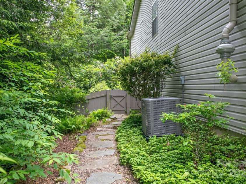 92 Nodatsi Court, Brevard, NC 28712.  MLS# CAR4268723, YatesRealty ID 24873. Meandering rock paths & gated for deer proof gardening...