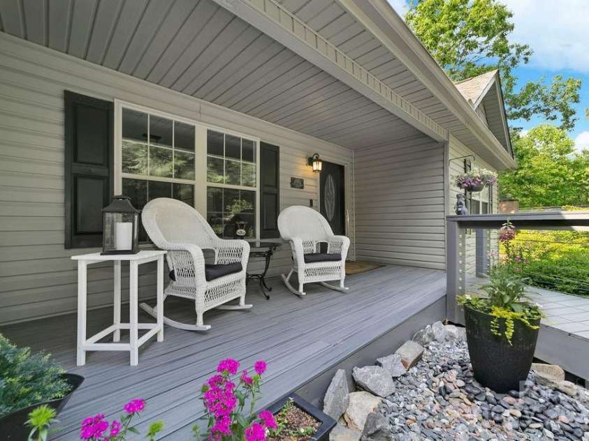 92 Nodatsi Court, Brevard, NC 28712.  MLS# CAR4268723, YatesRealty ID 24873. Rocking chair front porch