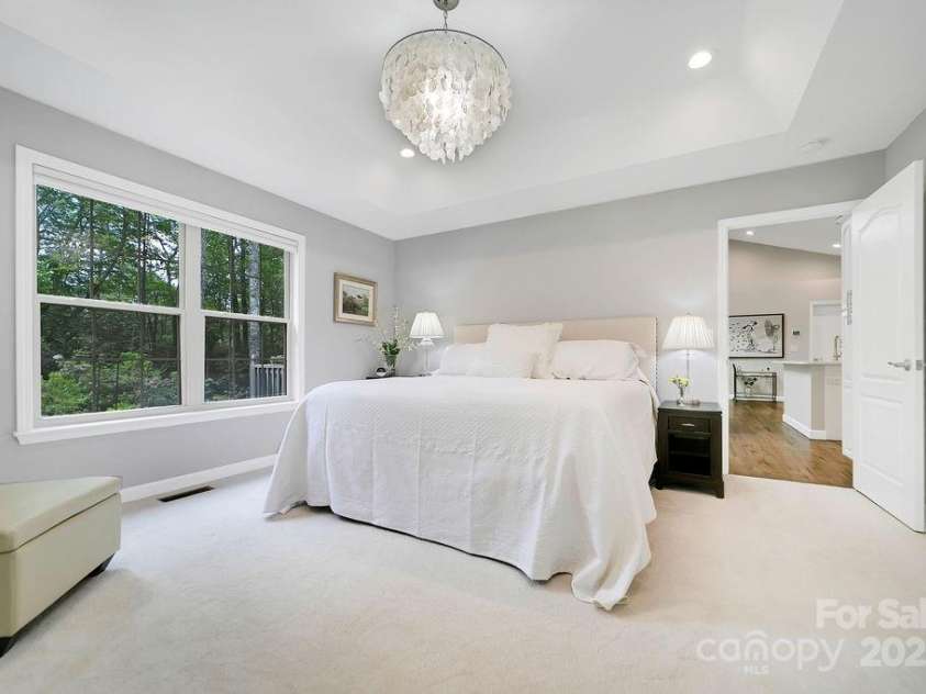 92 Nodatsi Court, Brevard, NC 28712.  MLS# CAR4268723, YatesRealty ID 24873. The lovely primary bedroom with garden views