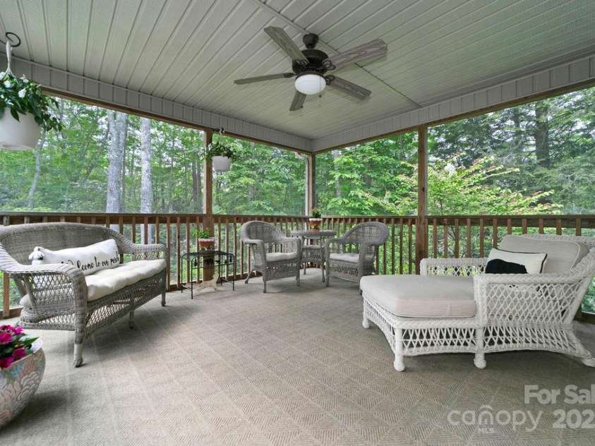 92 Nodatsi Court, Brevard, NC 28712.  MLS# CAR4268723, YatesRealty ID 24873. The screened porch is just off of the living room...