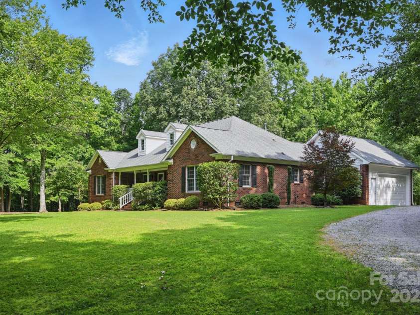 4824 Waxhaw Farms Road, Waxhaw, NC 28173.  MLS# CAR4270234, YatesRealty ID 24893. Another view of this fabulous brick home! The 2-car garage is as clean as a whistle and the epoxy flooring adds a  finishing touch! The long driveway also provides ample parking space!