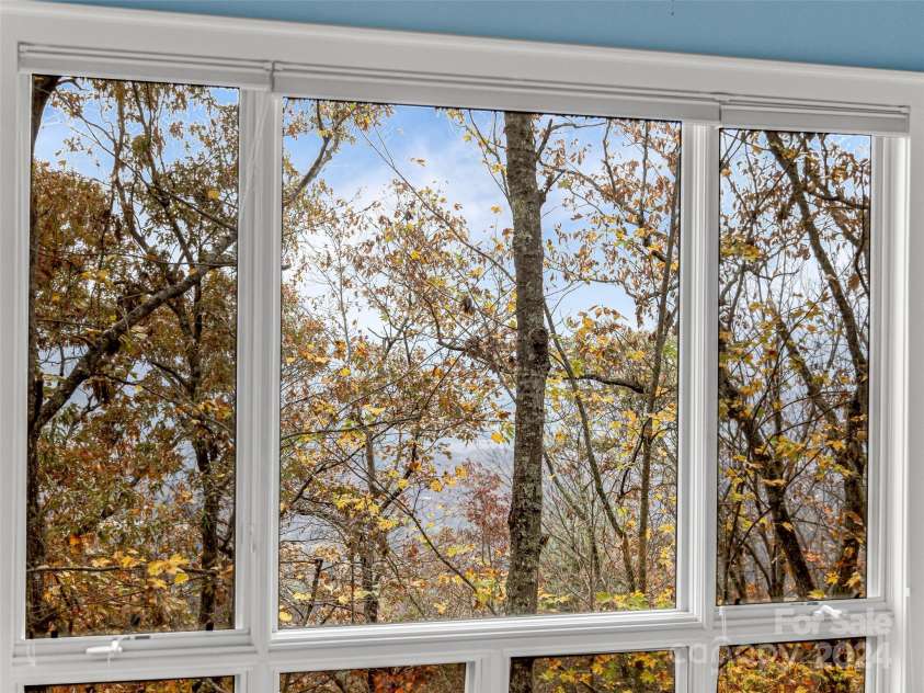 409 Elk Mountain Trail, Brevard, NC 28712.  MLS# CAR4196213, YatesRealty ID 249. Large windows throughout the house.