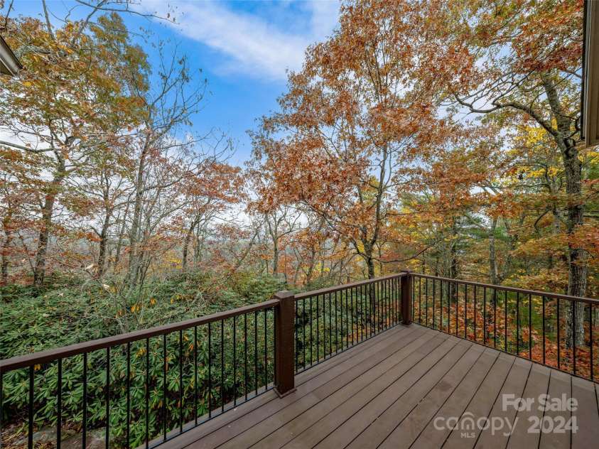 409 Elk Mountain Trail, Brevard, NC 28712.  MLS# CAR4196213, YatesRealty ID 249. Side open deck off Living Room