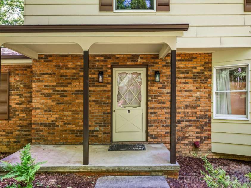11 Woodmere Drive, Arden, NC 28704.  MLS# CAR4382384, YatesRealty ID 24926. Front door and covered patio.