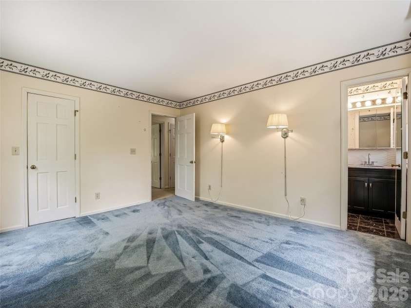 11 Woodmere Drive, Arden, NC 28704.  MLS# CAR4382384, YatesRealty ID 24926. Primary bedroom looking into primary bath.