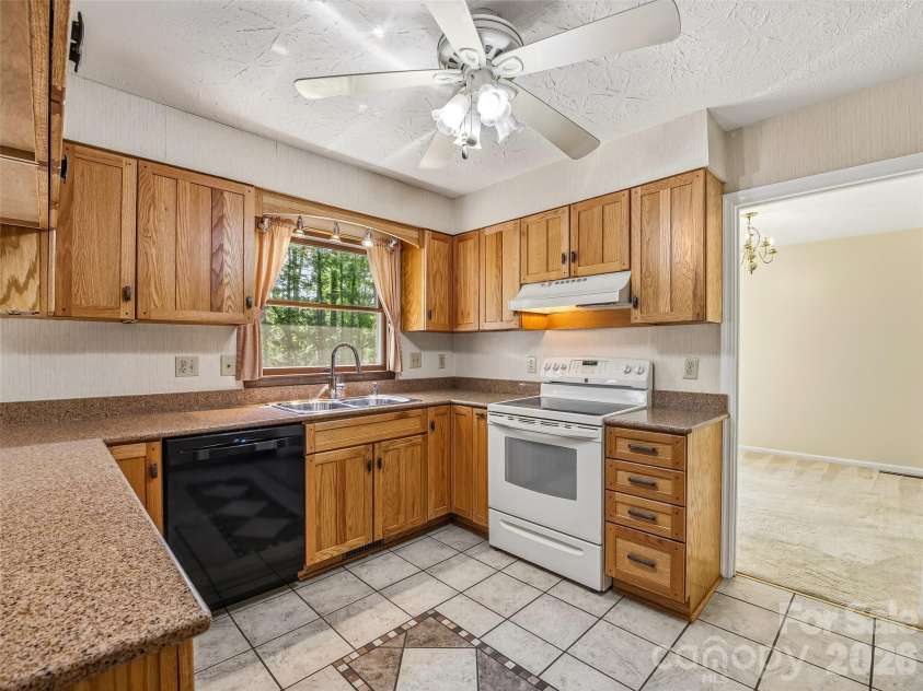 11 Woodmere Drive, Arden, NC 28704.  MLS# CAR4382384, YatesRealty ID 24926. Spacious, well-appointed kitchen with quartz countertops.