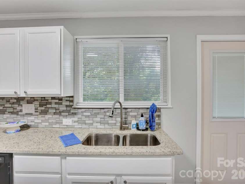 445 Peachtree Street, Albemarle, NC 28001.  MLS# CAR4385073, YatesRealty ID 24949. Kitchen sink overlooks deck and backyard....