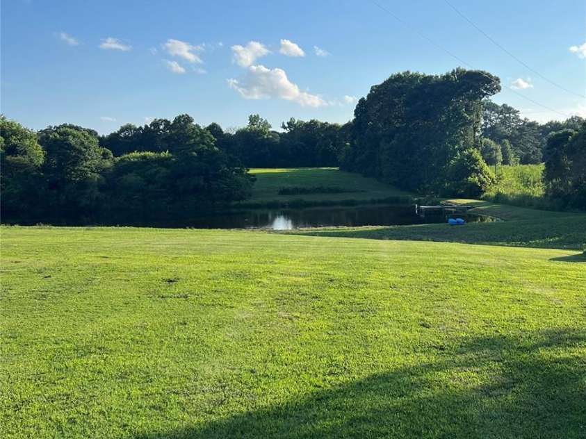 714 Helms Efird Road, Marshville, NC 28103.  MLS# CAR4263348, YatesRealty ID 24982. Back Yard Pond View