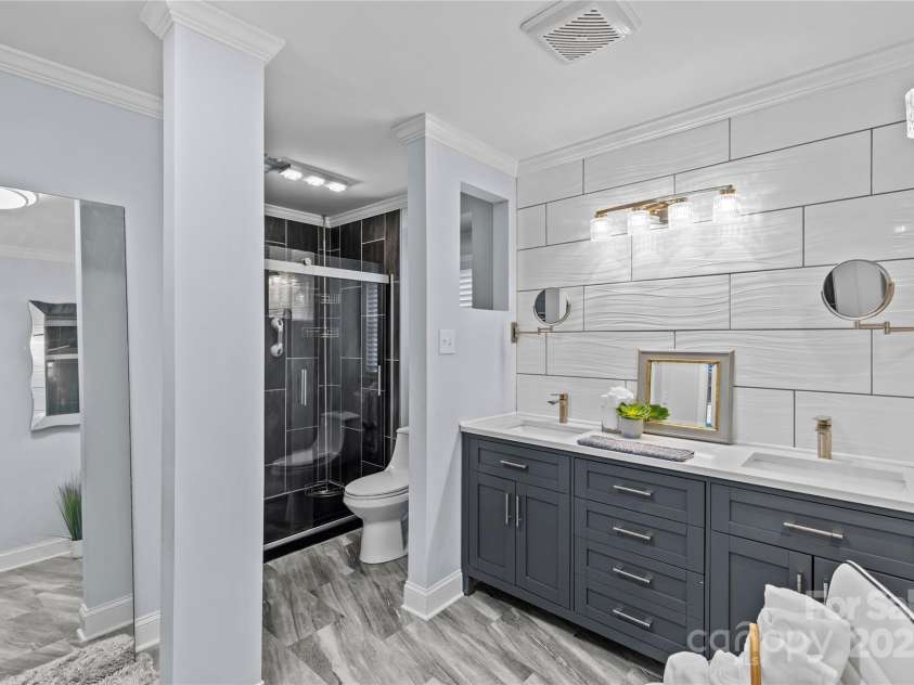 6035 Idlebrook Drive, Charlotte, NC 28212.  MLS# CAR4247653, YatesRealty ID 24986. Recent renovations to bathrooms. This primary en-suite bath and it's closet are amazing.