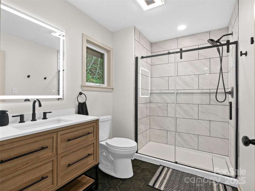 1065 Oak Ridge Lane, Mars Hill, NC 28754.  MLS# CAR4279845, YatesRealty ID 25012. Main Level Primary Bathroom