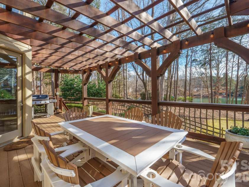 301 Agnew Road, Mooresville, NC 28117.  MLS# CAR4337466, YatesRealty ID 2502. Just off the kitchen is large deck w composite flooring a custom pergola. This helps create Many dining option...eat in kitchen banquet, dining room, or large outdoor porch overlooking the lake