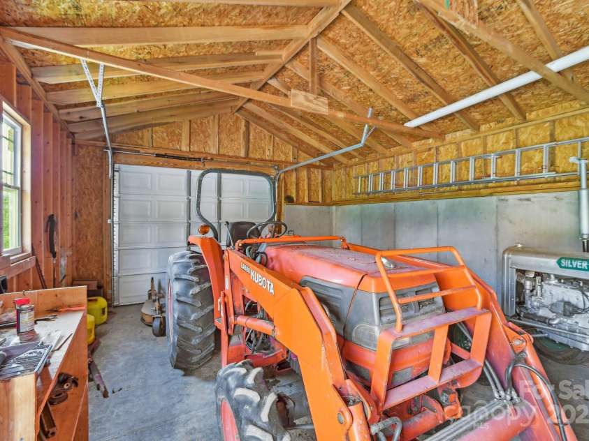 2281 Bearwallow Road, Edneyville, NC 28792.  MLS# CAR4234410, YatesRealty ID 25021. Detached garage with orange tractor that conveys!