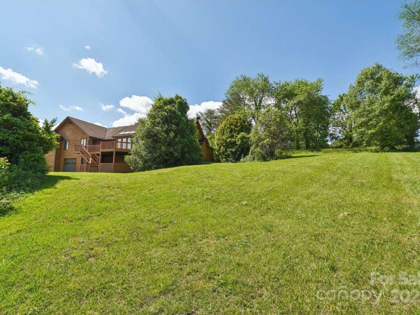2281 Bearwallow Road, Edneyville, NC 28792.  MLS# CAR4234410, YatesRealty ID 25021. Side yard