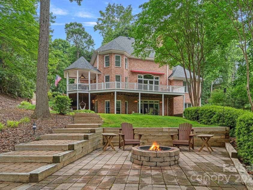 166 Pinnacle Shores Drive, Mooresville, NC 28117.  MLS# CAR4259986, YatesRealty ID 25031. Entertain around the firepit lakeside!