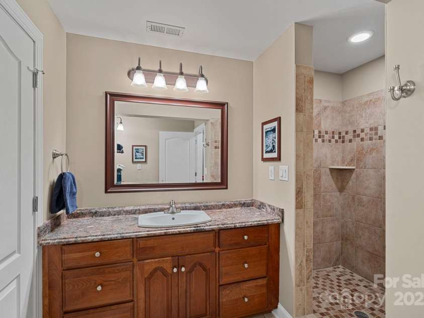 166 Pinnacle Shores Drive, Mooresville, NC 28117.  MLS# CAR4259986, YatesRealty ID 25031. Full bathroom on basement level between large bedroom and flex space currently used as bunk room