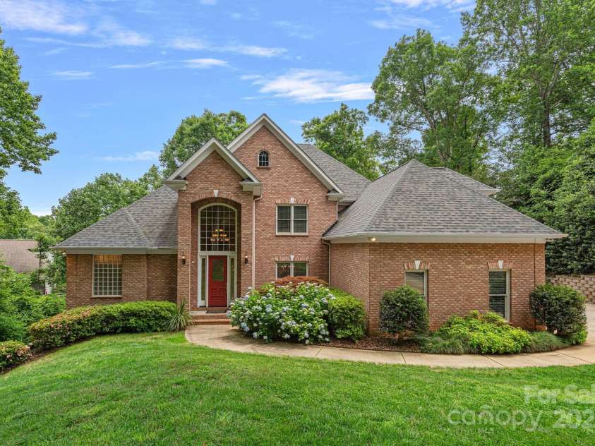 166 Pinnacle Shores Drive, Mooresville, NC 28117.  MLS# CAR4259986, YatesRealty ID 25031. Full brick home custom home on water with private dock!