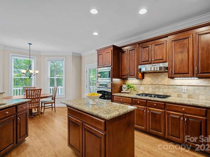 166 Pinnacle Shores Drive, Mooresville, NC 28117.  MLS# CAR4259986, YatesRealty ID 25031. Kitchen opens to breakfast and great room, side door leads to covered porch overlooking lake