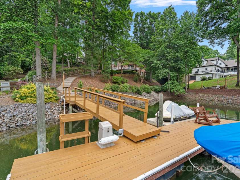 166 Pinnacle Shores Drive, Mooresville, NC 28117.  MLS# CAR4259986, YatesRealty ID 25031. Large dock and steps down to the lake! Stable shoreline