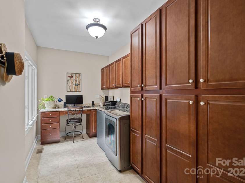166 Pinnacle Shores Drive, Mooresville, NC 28117.  MLS# CAR4259986, YatesRealty ID 25031. Large laundry room on main level. Loads of cabinetry for storage plus built in desk