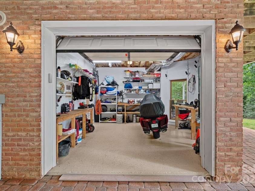 166 Pinnacle Shores Drive, Mooresville, NC 28117.  MLS# CAR4259986, YatesRealty ID 25031. Lower level / Basement workshop garage for all your lake toys