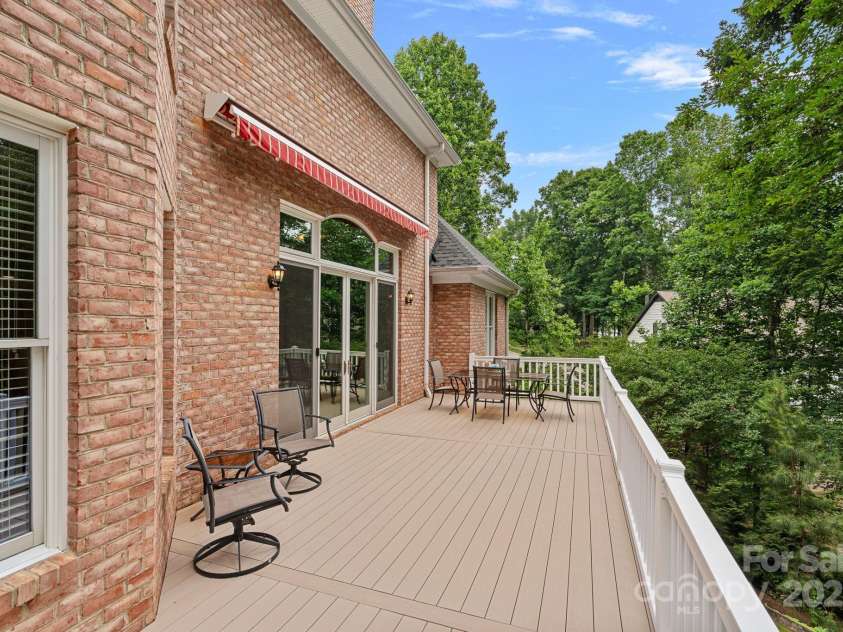 166 Pinnacle Shores Drive, Mooresville, NC 28117.  MLS# CAR4259986, YatesRealty ID 25031. Main level deck with beautiful large awning that covers your entertaining area if desired