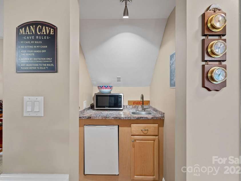 166 Pinnacle Shores Drive, Mooresville, NC 28117.  MLS# CAR4259986, YatesRealty ID 25031. Mini bar with refrigerator, sink perfectly set up for coffee bar for guests!