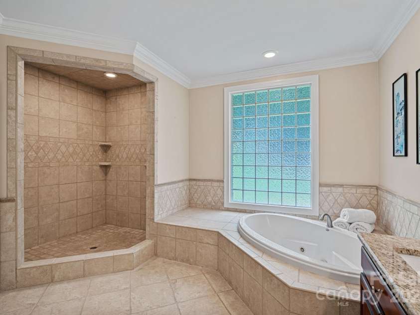 166 Pinnacle Shores Drive, Mooresville, NC 28117.  MLS# CAR4259986, YatesRealty ID 25031. Primary Bath with massive tiled shower and jacuzzi tub, dual vanity, private water closet and linen closet
