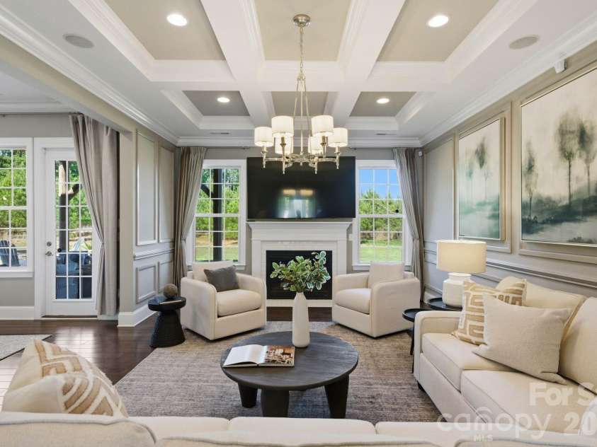 1020 Liggets Drive, Matthews, NC 28104.  MLS# CAR4369265, YatesRealty ID 25040. The great room features a coffered ceiling, mill work and fire place.