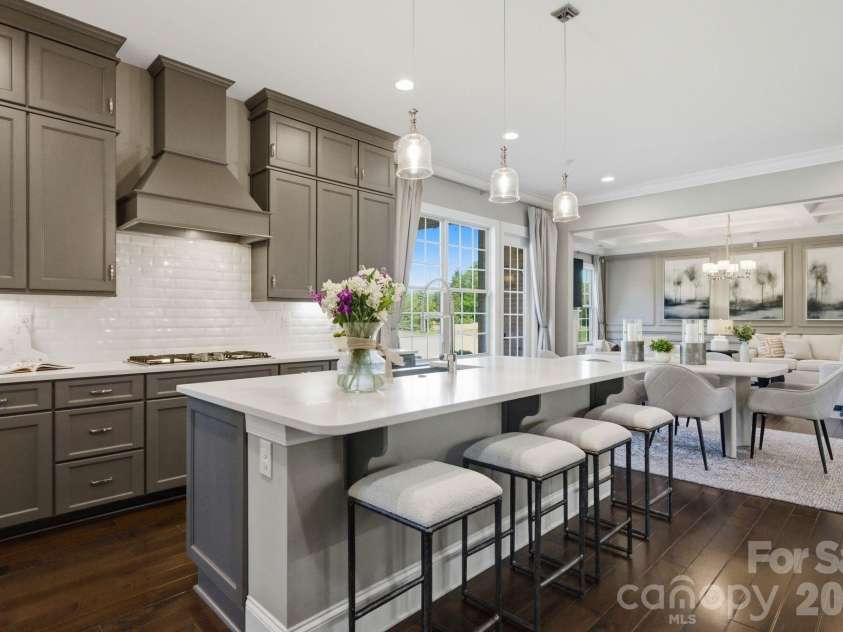 1020 Liggets Drive, Matthews, NC 28104.  MLS# CAR4369265, YatesRealty ID 25040. The kitchen has a large quartz kitchen island.