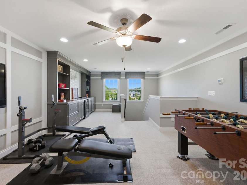 1020 Liggets Drive, Matthews, NC 28104.  MLS# CAR4369265, YatesRealty ID 25040. The third level flex space features built ins and a wine refrigerator