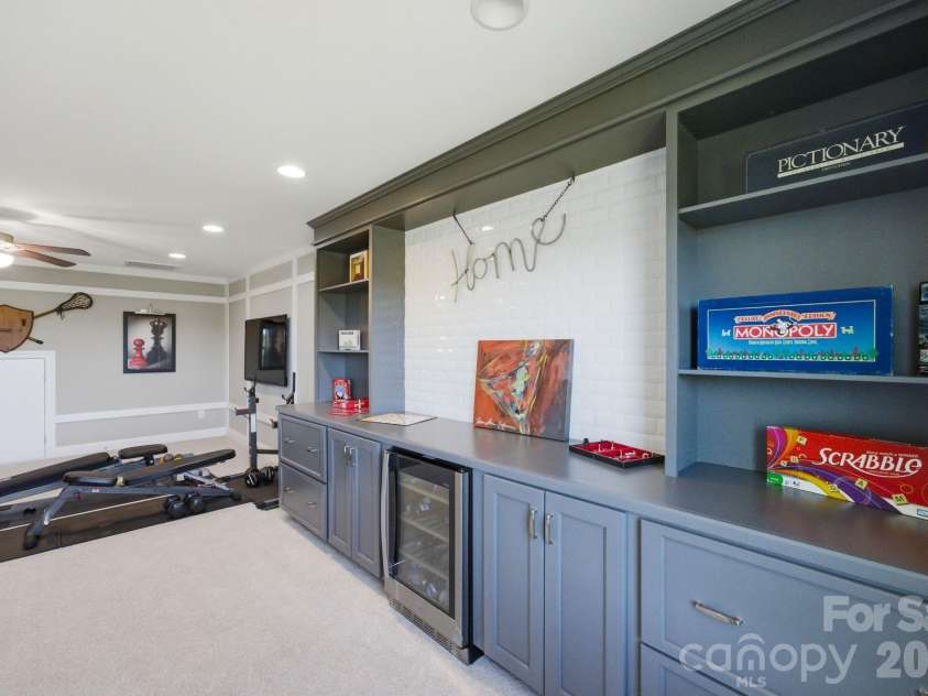 1020 Liggets Drive, Matthews, NC 28104.  MLS# CAR4369265, YatesRealty ID 25040. The third level flex space features built ins and a wine refrigerator