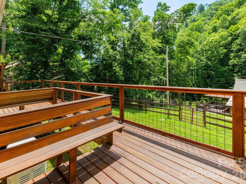 1010 and 1014 Melton Branch Road, Bakersville, NC 28705.  MLS# CAR4333369, YatesRealty ID 25045. Barndominium Front Deck