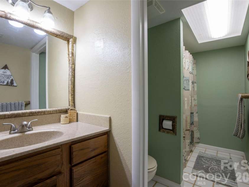 84 Sheets Farm Road, Bakersville, NC 28705.  MLS# CAR4384687, YatesRealty ID 25058. Down Stairs Batheroom