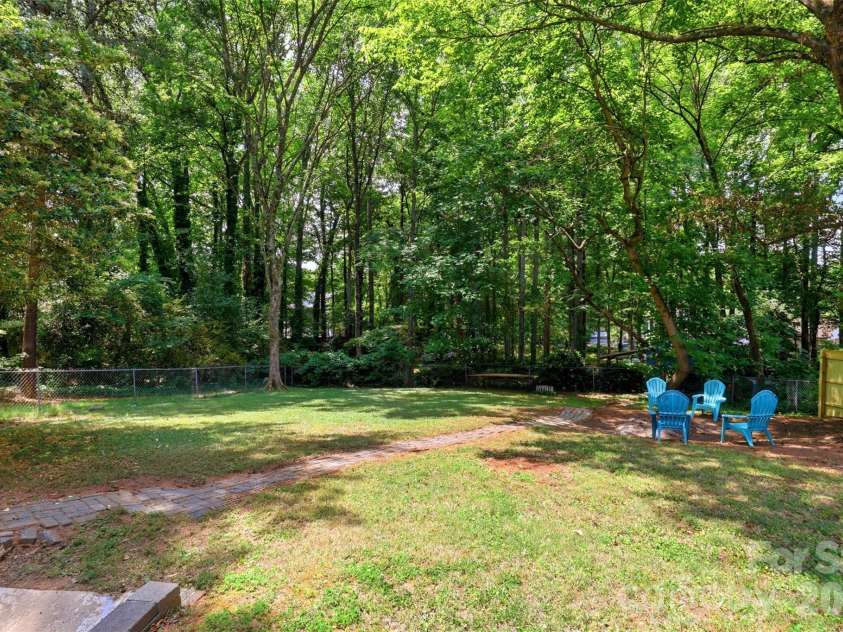 9624 Central Drive, Mint Hill, NC 28227.  MLS# CAR4385094, YatesRealty ID 25062. A firepit area has been created under a large shade tree in the rear