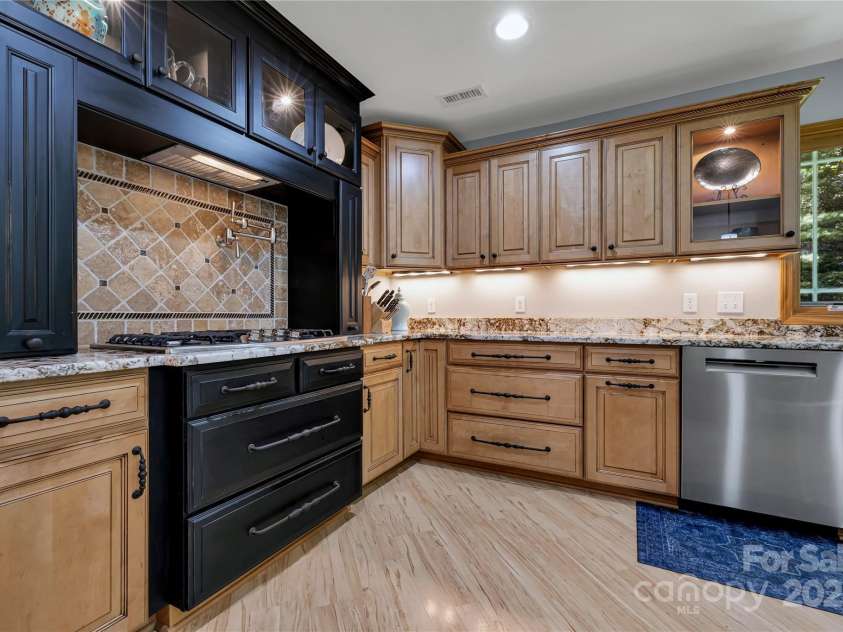 16 Due West Road, Hendersonville, NC 28792.  MLS# CAR4274720, YatesRealty ID 25064. Travertine tile featured backsplash