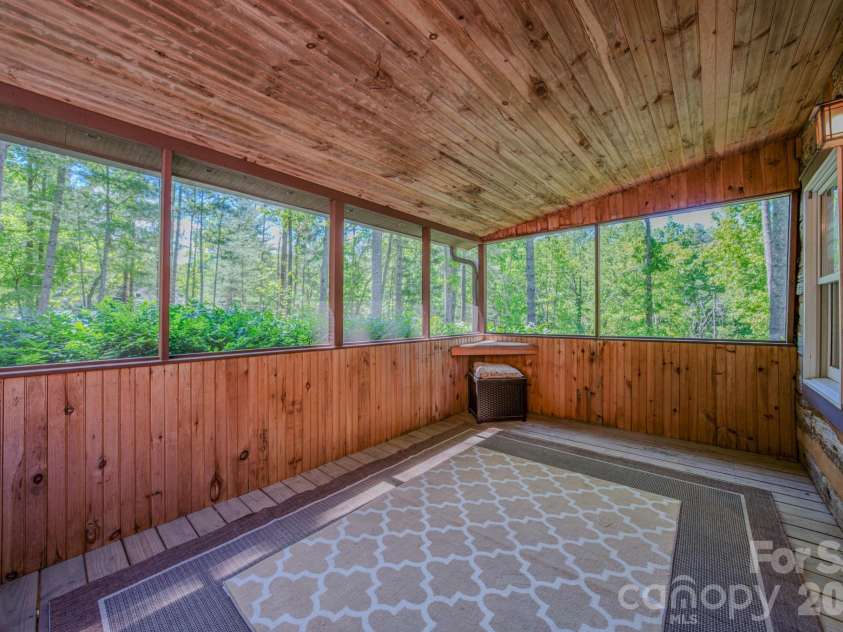 75 Old Gap Creek Road, Fairview, NC 28730.  MLS# CAR4378192, YatesRealty ID 25066. Screened porch off den