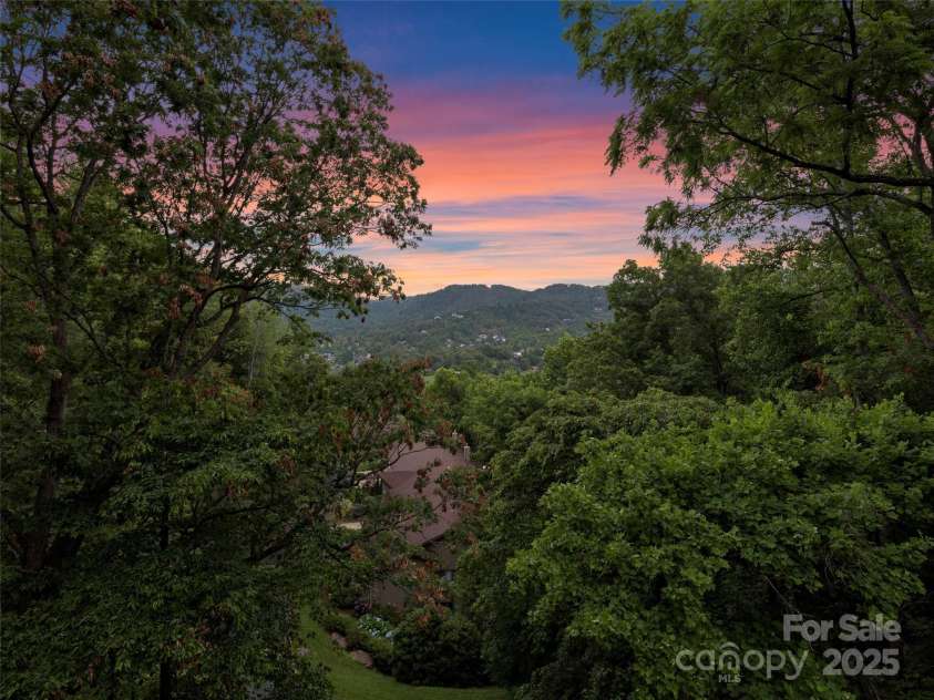 3301 Timber Trail, Asheville, NC 28804.  MLS# CAR4270898, YatesRealty ID 25068. Drone view of 3301 Timber Trail at twilight.
