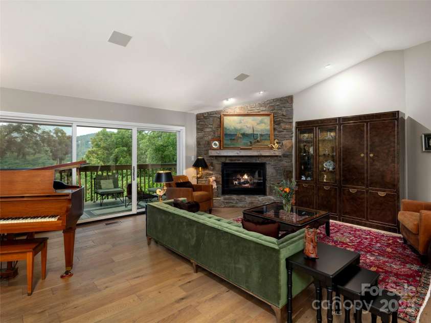 3301 Timber Trail, Asheville, NC 28804.  MLS# CAR4270898, YatesRealty ID 25068. Spacious living room with gas fire place and views.