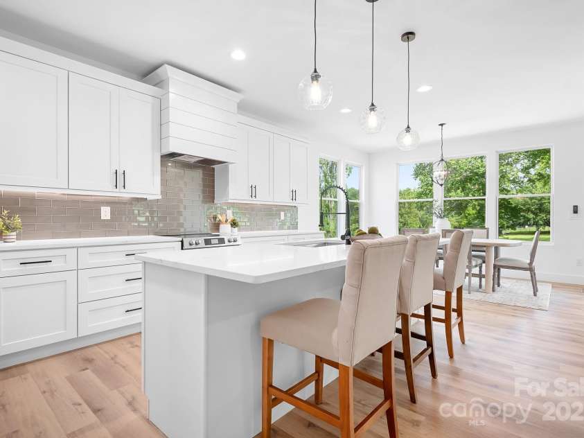 104 Arbor Drive, Waxhaw, NC 28173.  MLS# CAR4258251, YatesRealty ID 25109. A seamless flow from kitchen to dining makes entertaining effortless—and those oversized windows bring the outdoors right in.