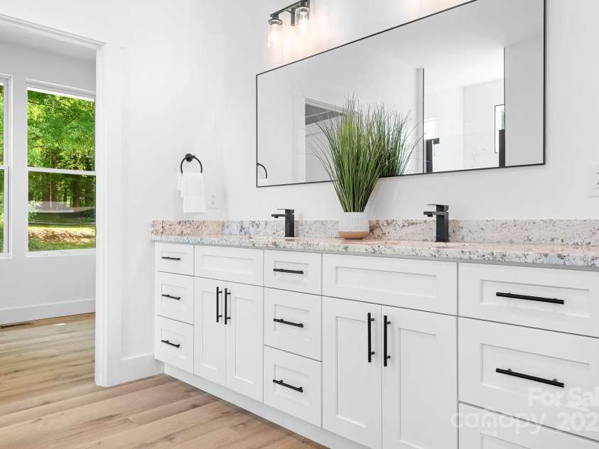 104 Arbor Drive, Waxhaw, NC 28173.  MLS# CAR4258251, YatesRealty ID 25109. Bright, clean, and full of function. This ensuite bathroom brings calm and convenience together in one sleek package.