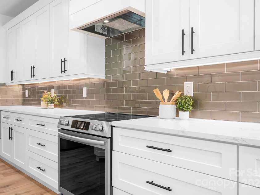 104 Arbor Drive, Waxhaw, NC 28173.  MLS# CAR4258251, YatesRealty ID 25109. Clean lines, custom cabinetry, and a designer backsplash that ties it all together—this kitchen is as functional as it is beautiful.