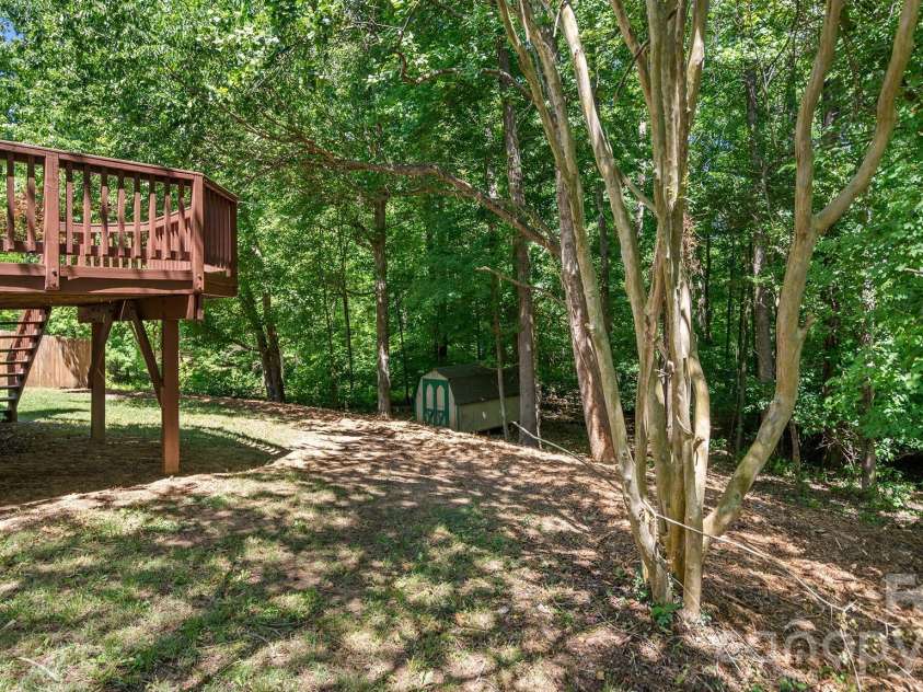 8815 Burnt Umber Drive, Charlotte, NC 28215.  MLS# CAR4384212, YatesRealty ID 25126. Private Tree Lined Lot - Easy to Maintain