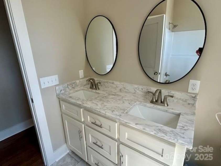 141 Maplewood Court, Hudson, NC 28638.  MLS# CAR4279245, YatesRealty ID 25127. Hall bathroom with double sinks and solid surface counter top.
