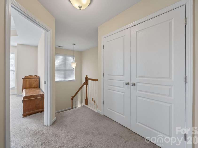 11156 Green Spring Drive, Huntersville, NC 28078.  MLS# CAR4353503, YatesRealty ID 25135. Upper Level Hallway (Laundry Doors Closed)