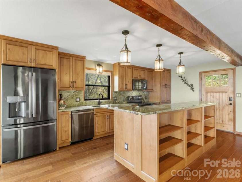 49 Slickrock Ridge Way, Burnsville, NC 28714.  MLS# CAR4367218, YatesRealty ID 25177. Kitchen island with built-ins